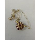 A 14 ct gold ruby and diamond cluster pendant, marked 585, (3cm x 2cm) chain marked 9ct, combined