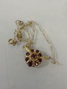 A 14 ct gold ruby and diamond cluster pendant, marked 585, (3cm x 2cm) chain marked 9ct, combined