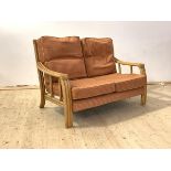 A late 20th century bamboo two seat veranda sofa with upholstered squab cushions, H89cm, W130cm,
