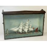 A diorama of a three masted schooner, a sail boat and lighthouse, in glazed display case, ( 41cm x
