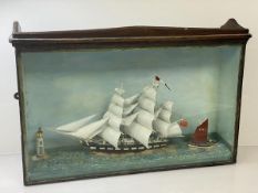 A diorama of a three masted schooner, a sail boat and lighthouse, in glazed display case, ( 41cm x