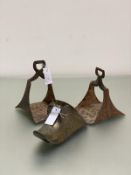 A pair of 19thc cast iron stirrups of shaped upswept form and a Dutch style brass clog shaped