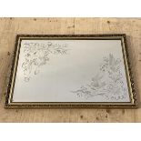 A Bevelled and etched wall hanging mirror in gilt composition frame 58cm x 84cm