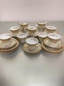 A Noritake 33-piece tea set decorated with lotus leaf and floral polychrome enamel decorated border