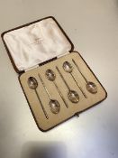 A set of six Walker and Hall Sheffield silver coffee spoons, Sheffield 1938, with feathered