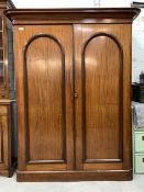 A Victorian mahogany wardrobe, with two panelled doors enclosing interior with slides, drawers an