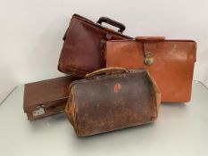 A group of four vintage leather cases including a Gladstone style bag, two large document carrying