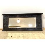 A 1930's carved oak over mantel mirror with rectangular bevelled plate, 132cm x 56cm