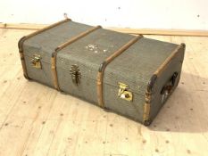 A travelling trunk, first half of the 20th century, wooden bound and with leather carry handle to