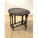 An 18th century style gate leg table, the oval top with floral lunette incised carved band over