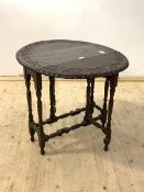 An 18th century style gate leg table, the oval top with floral lunette incised carved band over