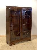 A glazed oak floor standing bookcase, circa 1930's, with three shelves (two glass panels cracked)