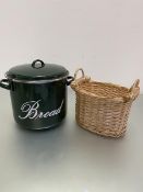 A modern green circular enamel bread bin, (h 25cm x d 27cm), and a wicker baguette or loaf basket (