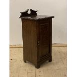 A late Victorian stained oak bedside cabinet, the raised back over single panelled door, stile