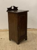 A late Victorian stained oak bedside cabinet, the raised back over single panelled door, stile