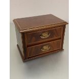 An Edwardian mahogany boxwood strung nest of two drawers the rectangular top with moulded edge above
