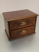 An Edwardian mahogany boxwood strung nest of two drawers the rectangular top with moulded edge above