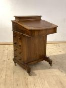 A Victorian inlaid walnut davenport, the raised back with stationary box over inset leather