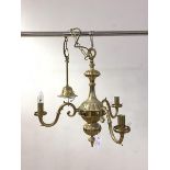 A Dutch style gilt brass three branch chandelier with chain and ceiling rose, H53cm