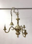 A Dutch style gilt brass three branch chandelier with chain and ceiling rose, H53cm