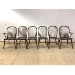 A set of six (4+2) oak Windsor chairs, with hoop and spindle back rest over saddle seats, raised