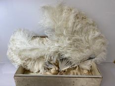 An early 20thc ladies ostrich feather and mother of pearl fan, marked Carrie, (41cm x 64cm) a/f,