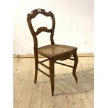 A late 19th century walnut bedroom chair, with rail back, cane seat, raised on cabriole front