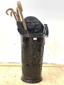 A Victorian style hammered metal umbrella stand, (H82cm) together with a collection of walking