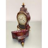 A Louis XVI style moulded composition baluster mantel clock with gilt mounted top and circular