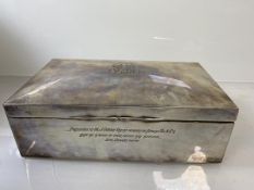 A silver cigarette box, Birmingham circa 1910, with monogram to top, inscribed to front Presented to