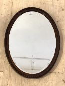 An early 20th century mahogany framed wall hanging mirror with bevelled glass, 74cm x 52cm