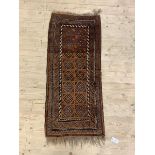 An old Persian Balouch runner, the brown field with geometric design, 138cm x 57cm