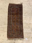 An old Persian Balouch runner, the brown field with geometric design, 138cm x 57cm