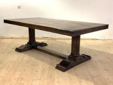 A large oak refectory style dining table of 18th century design, the thick panelled top over two