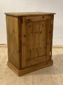 A modern waxed pine floor standing cupboard, one door enclosing two shelves, H87cm, W68cm, D40cm