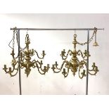 A pair of gilt brass Dutch style chandeliers, each with ceiling rose, chain and twelve scrolled