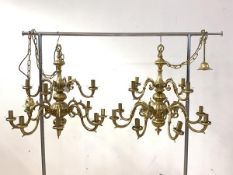 A pair of gilt brass Dutch style chandeliers, each with ceiling rose, chain and twelve scrolled