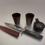 A stag's horn handled knife and leather scabbard, two trench art tapered cylinder brass beakers, (