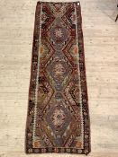 An old and well worn Kilim runner of typical geometric design, 312cm x 100cm