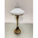 A brass oil lamp style lamp with opaque glass shade complete with glass funnel on circular stepped