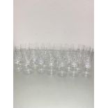 A part set of glassware including four large brandy snifters, six crystal slice cut champagne