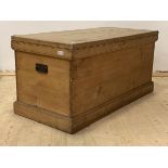 A Large 19th century pine coffer, with hinged lid, carry handle to each end, on a skirted base,