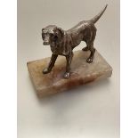 A white metal cast model of a golden retriever mounted on alabaster base, (h 12cm including base x