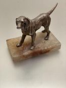 A white metal cast model of a golden retriever mounted on alabaster base, (h 12cm including base x