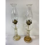 A pair of Edwardian glass oil lamps with spiral twisted bases and full length reservoir (h 45cm),