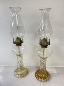 A pair of Edwardian glass oil lamps with spiral twisted bases and full length reservoir (h 45cm),