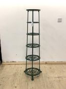 A green pained cast metal pan stand, with six graduated tiers, raised on paw supports, H123cm,