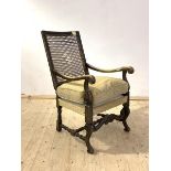 A 17th century style stained walnut(?) open arm chair, with cane back panel(A/F), scrolled arm