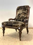 A Victorian upholstered and mahogany framed drawing room chair, raised on turned and fluted supports