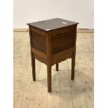 An early 20th century mahogany sewing table, the hinged top over drawer to side, raised on square